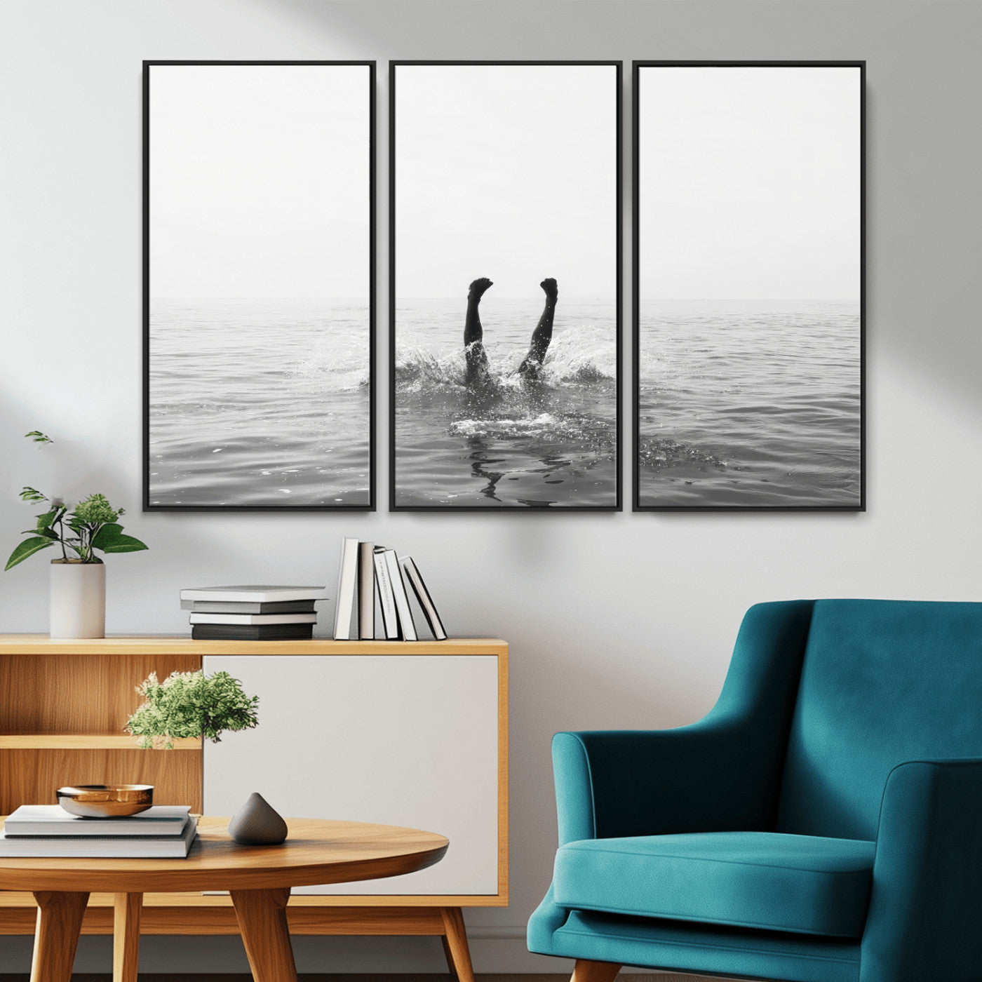 A black and white minimalist water scene capturing a playful splash as a swimmer dives upside down, creating a carefree and artistic aquatic aesthetic.