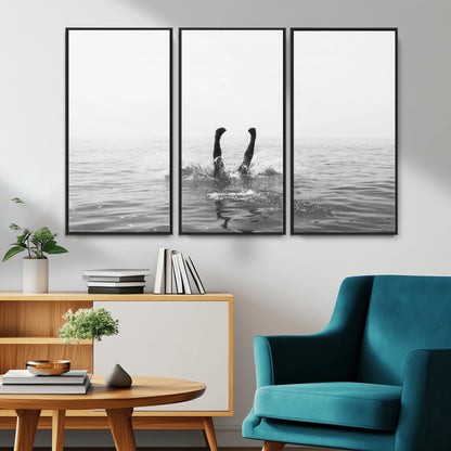 A black and white minimalist water scene capturing a playful splash as a swimmer dives upside down, creating a carefree and artistic aquatic aesthetic.