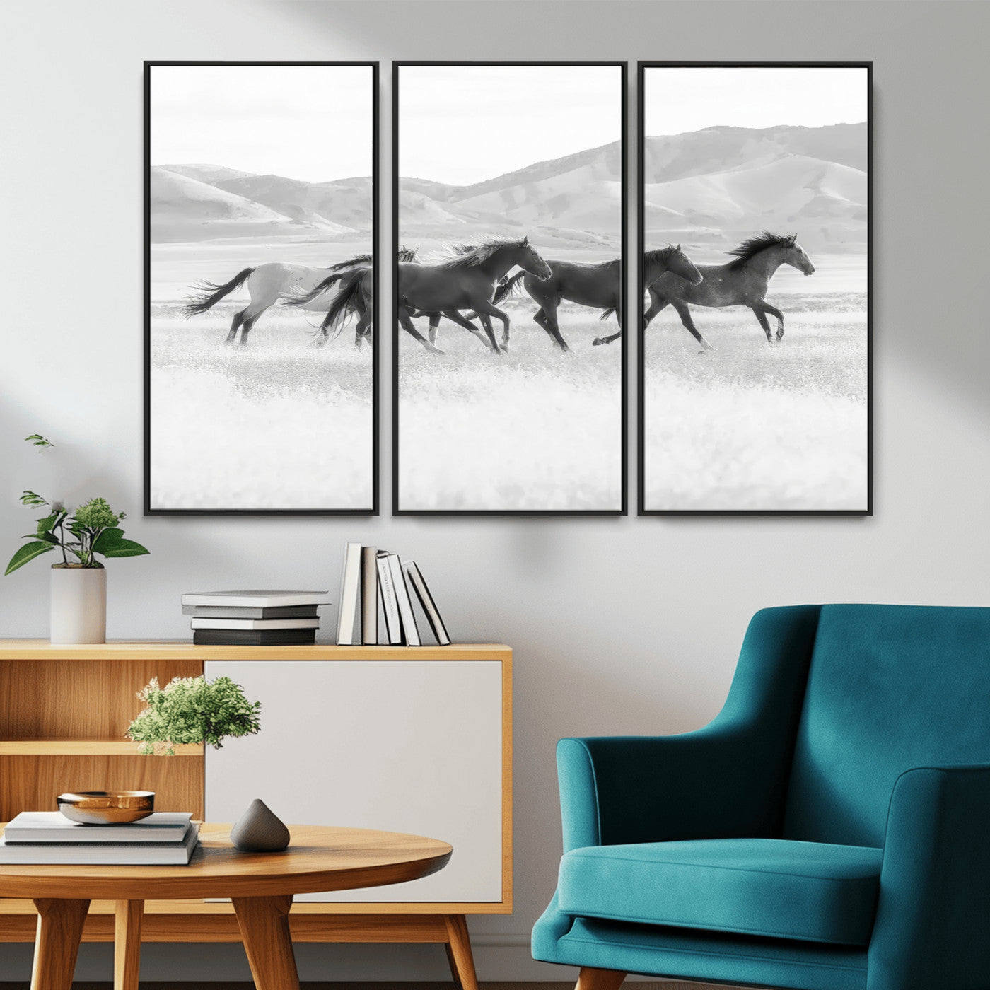 A black and white image of wild horses running freely across an open grassland, capturing the power and beauty of untamed nature in a rustic western setting.