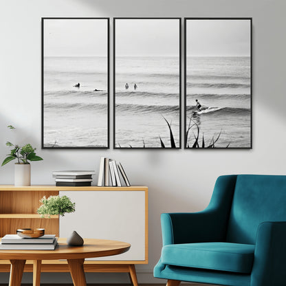 Monochrome canvas of surfers on calm ocean waves, ideal for minimalist coastal or beach-inspired interior decor.