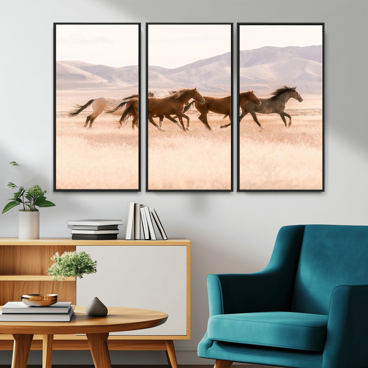 A herd of wild horses galloping through a sunlit desert plain with mountains in the background, perfect for rustic or western-themed wall decor.