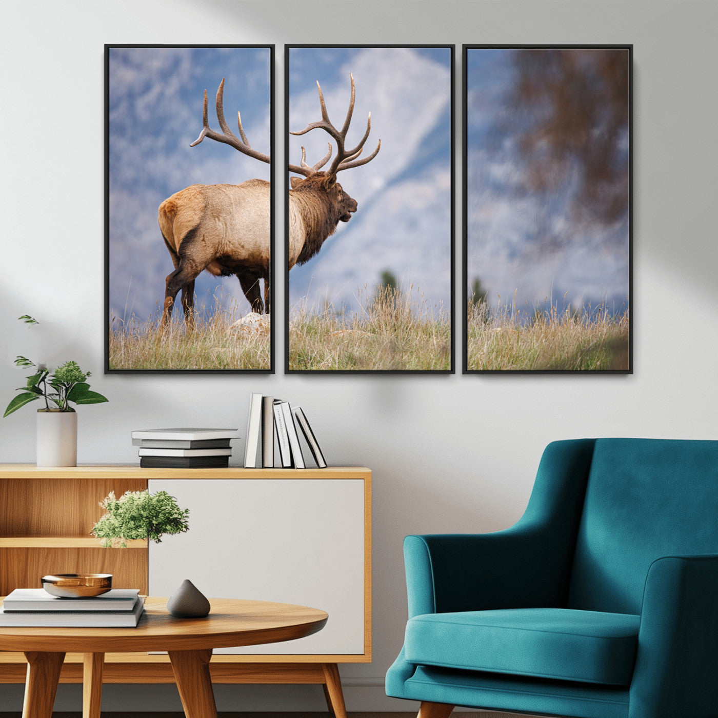 Elk with antlers standing on grass with mountain background, ideal for rustic, cabin, or lodge-inspired wall decor.