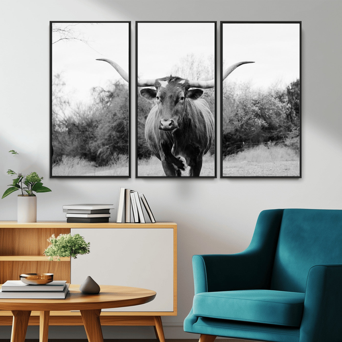Black and white photo of a longhorn cow in a field, perfect for rustic farmhouse or western-themed interior wall decoration.