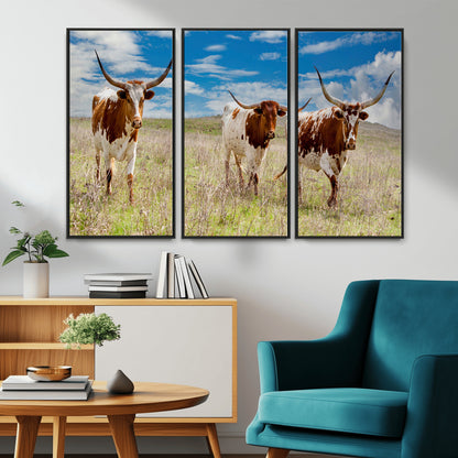 Three Texas longhorn cattle standing in dry grass under a bright blue sky, ideal for farmhouse or western rustic home decor.
