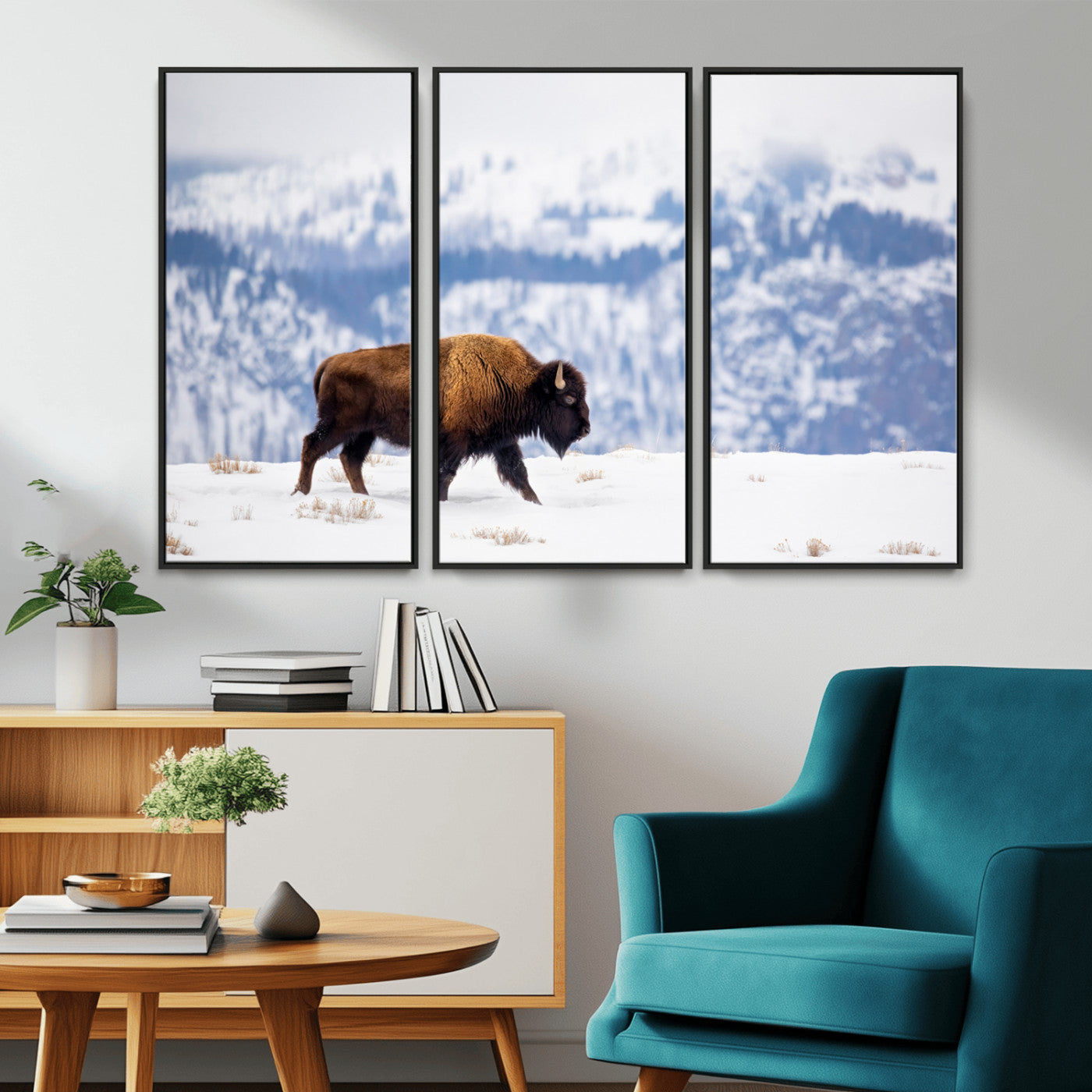 A lone bison walks across snowy ground with blue-toned mountain range behind, ideal for rustic or western farmhouse interiors.