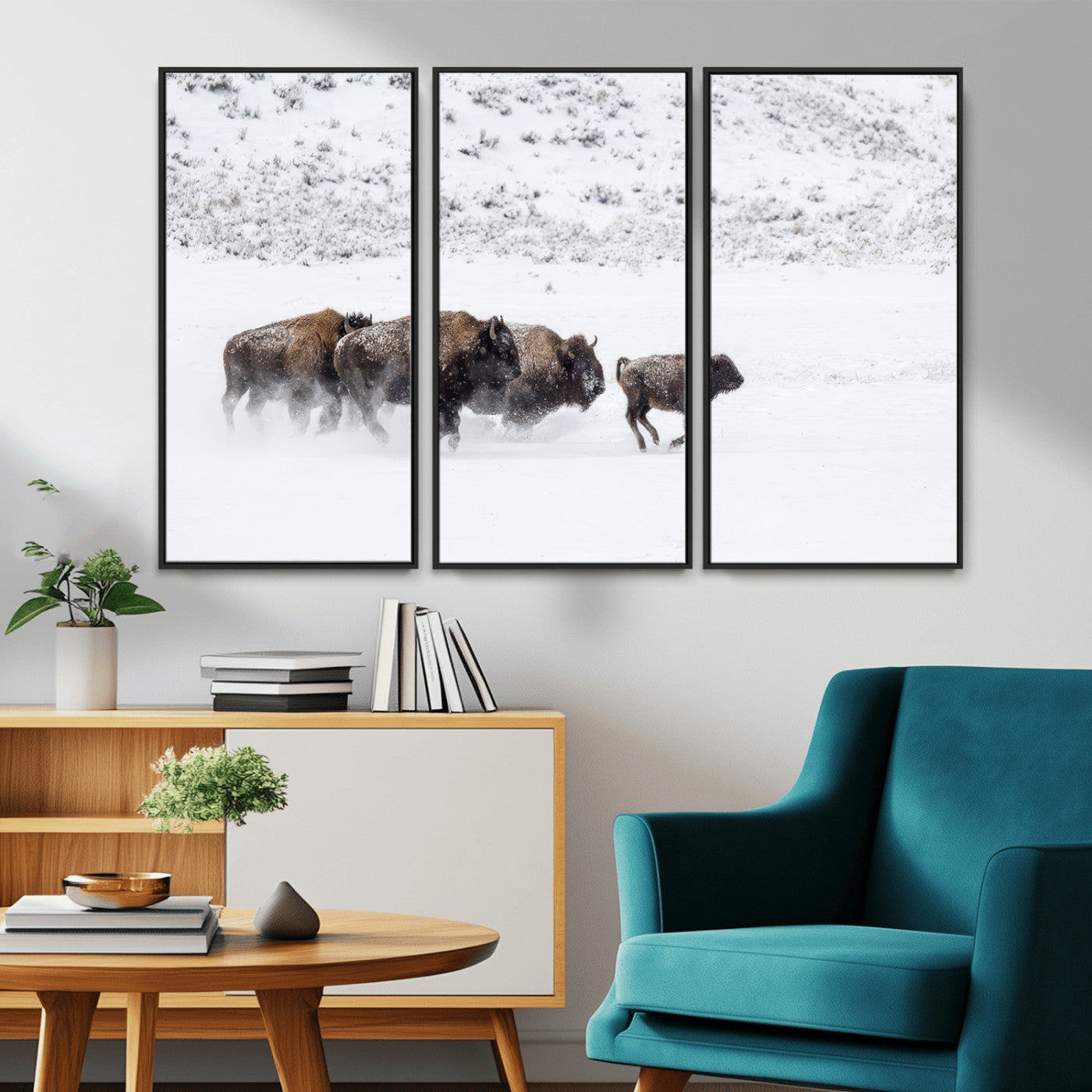 Bison herd running through a snowy open field with mountain backdrop, perfect for rustic or western-themed wall decoration.