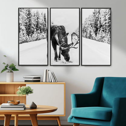 A majestic moose grazing in the snow-covered wilderness, surrounded by snow-covered trees, creating a peaceful winter scene.
