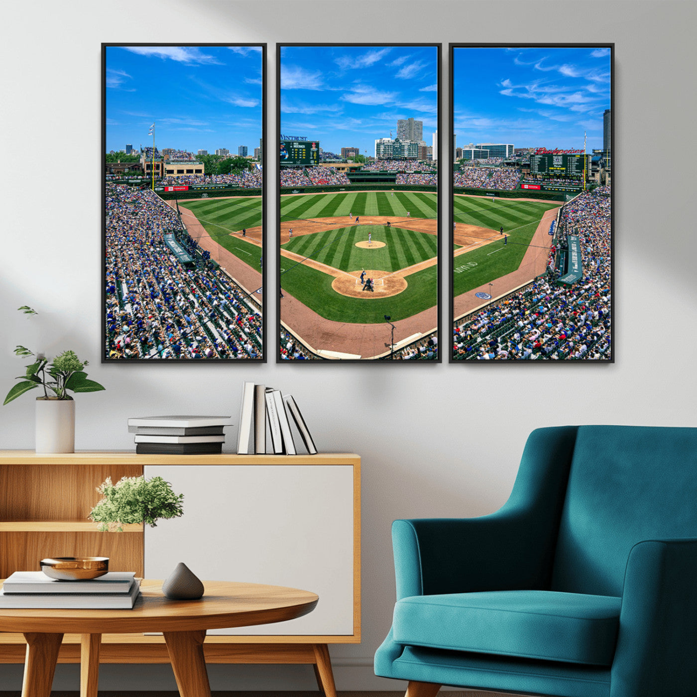 A wide-angle shot of a baseball field filled with spectators, with players on the field and the iconic Wrigley Field scoreboard in the background.