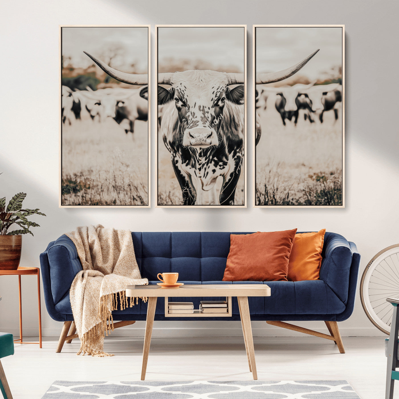 Canvas of a speckled Texas longhorn standing boldly in a field with a herd behind, perfect for rustic western or farmhouse wall decor.
