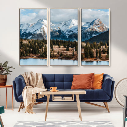 Framed canvas of snowy mountain peaks with pine forest and alpine lake, perfect for winter cabin or wilderness-inspired home decor.
