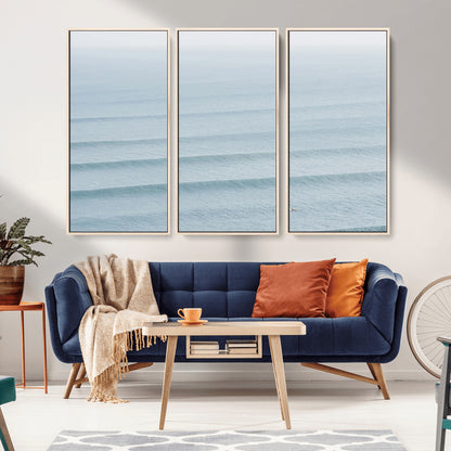 Framed canvas of repeating ocean waves with a distant solo surfer, ideal for minimalist ocean or calm coastal wall decor.