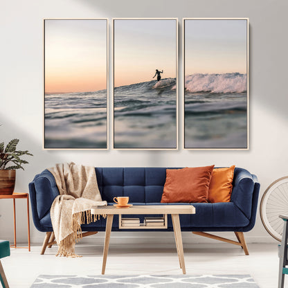 Framed canvas of a female surfer balancing on a wave at sunset, perfect for serene surf or ocean-inspired coastal decor.