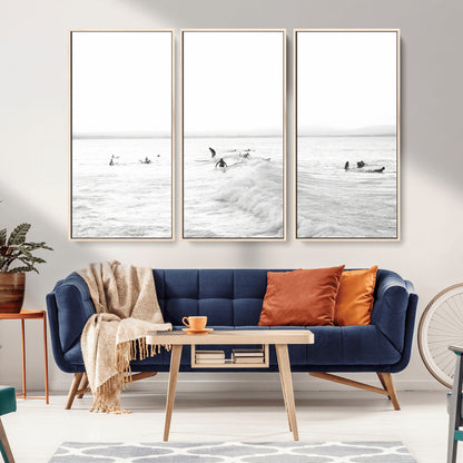 Monochrome photo of surfers riding and waiting on ocean waves, ideal for surf-themed or coastal energy wall decor.