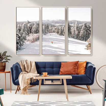 Bright ski trail lined with snow-covered pines and a skier in orange, perfect for alpine adventure or winter sports-inspired decor.