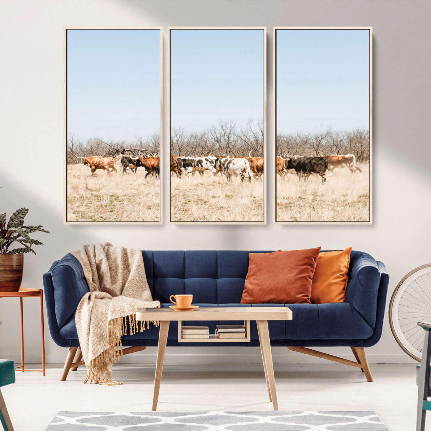 Framed wall art of Texas longhorn cattle walking through a dry, neutral-toned prairie, perfect for rustic farmhouse or western-themed home decor.
