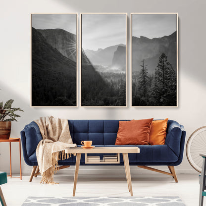 Black and white landscape of Yosemite with sun rays peeking over El Capitan, ideal for moody nature or modern rustic decor.