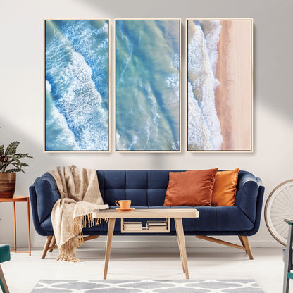 Aerial photo of soft blue waves meeting sandy shore, perfect for modern coastal or beach-themed decor with a light and tranquil aesthetic.