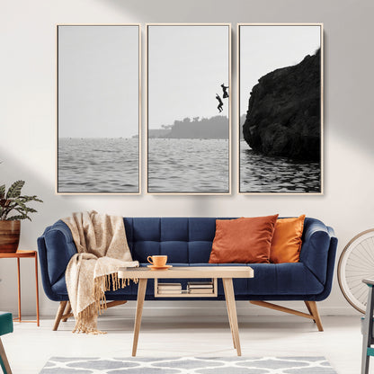 Black and white canvas of two figures cliff jumping into the sea, captured with moody tones, ideal for modern coastal or adventure-themed home decor.   2/2