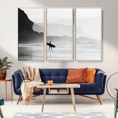 A lone surfer walking along a misty beach with cliffs in the background, carrying their board, capturing a serene and minimal ocean moment.