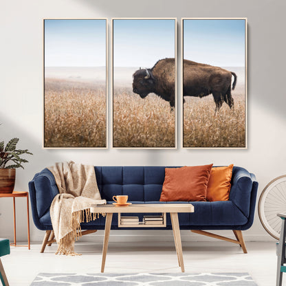 A majestic bison standing in an open prairie field, its strong form blending into the golden grass under a vast blue sky, evoking the wild spirit of the American plains.