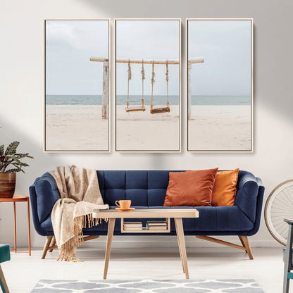 A rustic wooden beach swing stands on a serene sandy shore with an ocean horizon in the background, creating a tranquil and dreamy coastal escape.