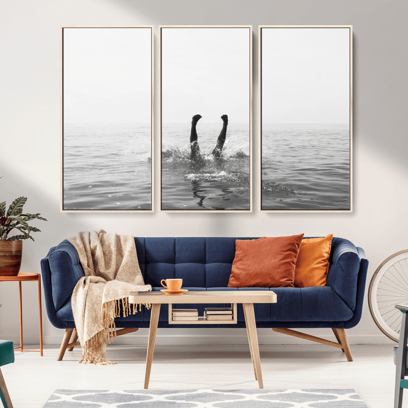 A black and white minimalist water scene capturing a playful splash as a swimmer dives upside down, creating a carefree and artistic aquatic aesthetic.