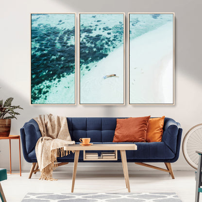 Canvas featuring an aerial view of a swimmer in shallow turquoise waters with coral patterns, ideal for tropical coastal home decor.