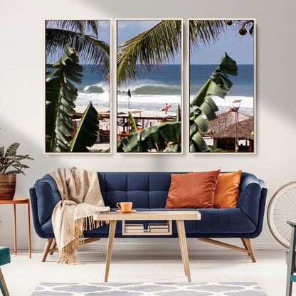 Canvas wall art of a tropical surf scene framed by palm trees, with a surfer on the shore and waves rolling in, ideal for beach-themed decor.