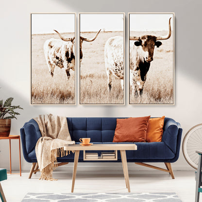 Two Texas longhorn cows standing in a sepia-toned pasture, evoking rustic charm perfect for farmhouse or western country interiors. (
