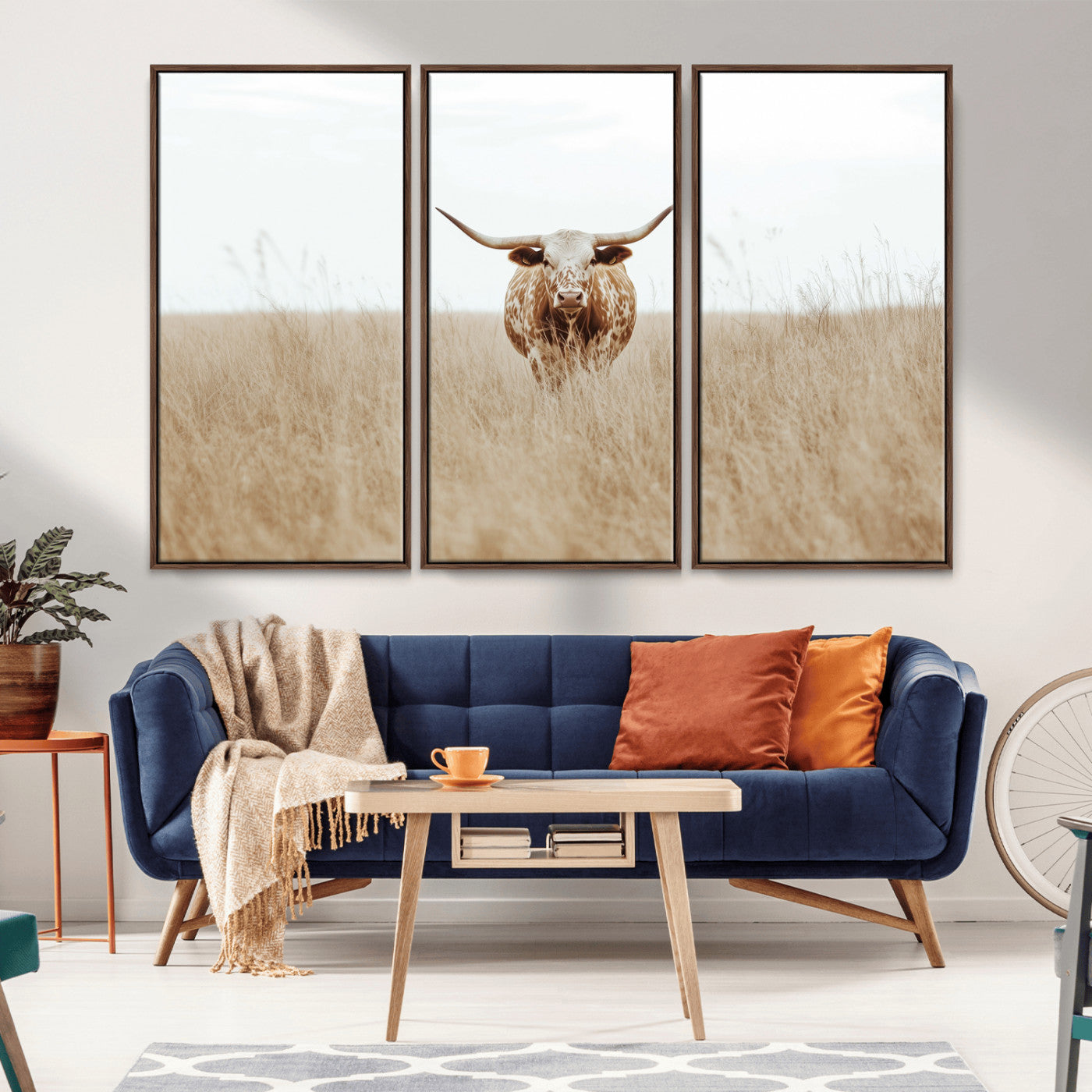 Texas Longhorn bull standing alone in dry grass with neutral tones, ideal for rustic western or cowboy-themed wall decor.