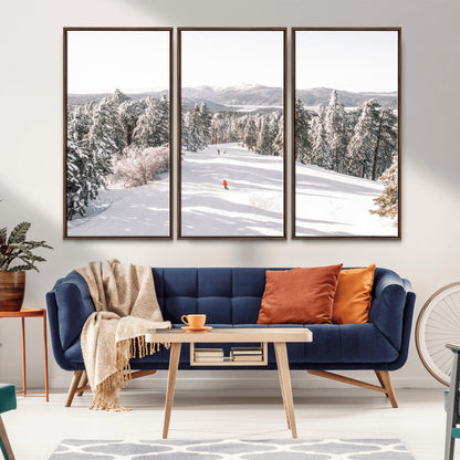 Bright ski trail lined with snow-covered pines and a skier in orange, perfect for alpine adventure or winter sports-inspired decor.