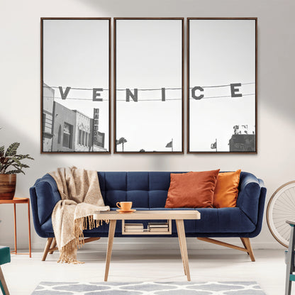 Black and white photo of Venice Beach sign and palm-lined street, perfect for urban coastal or minimalist LA-inspired wall decoration.