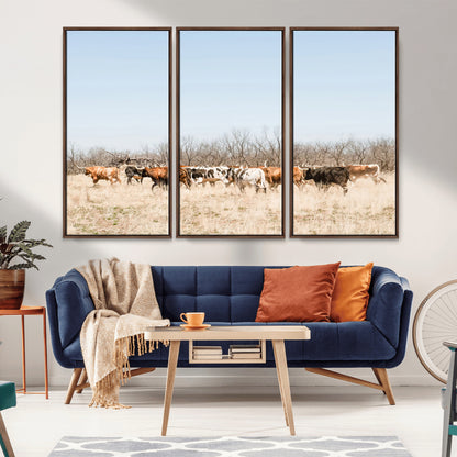 Framed wall art of Texas longhorn cattle walking through a dry, neutral-toned prairie, perfect for rustic farmhouse or western-themed home decor.