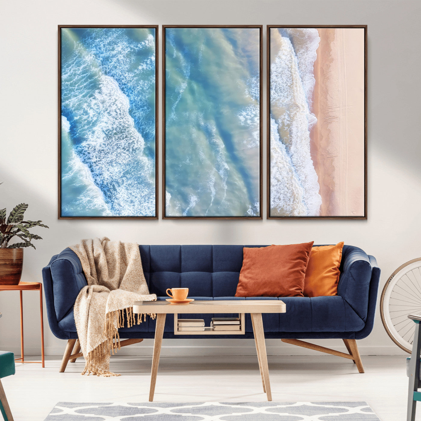 Aerial photo of soft blue waves meeting sandy shore, perfect for modern coastal or beach-themed decor with a light and tranquil aesthetic.