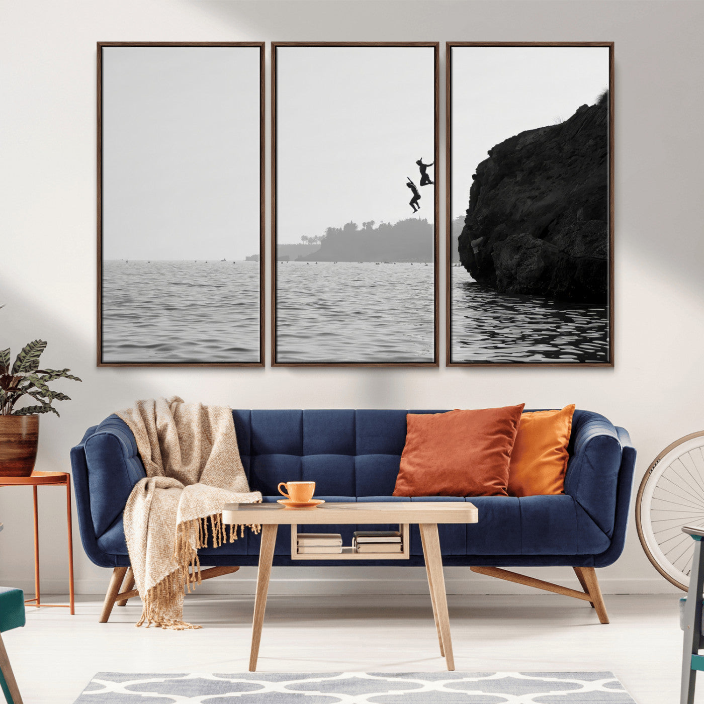 Black and white canvas of two figures cliff jumping into the sea, captured with moody tones, ideal for modern coastal or adventure-themed home decor.   2/2