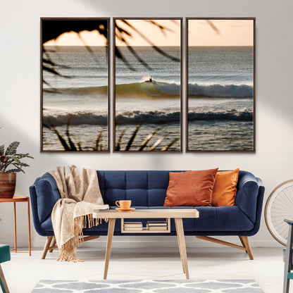 Photo of a surfer riding a golden hour wave at sunset, with tropical tones and dreamy light, perfect for tropical boho or coastal home decor.