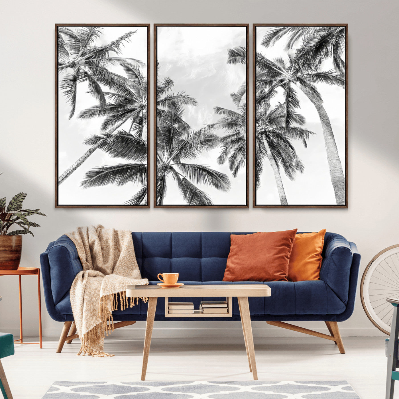 Black and white tropical palm trees viewed from below, swaying gently against a bright sky, creating a serene and elegant coastal atmosphere.