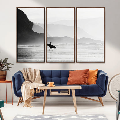 A lone surfer walking along a misty beach with cliffs in the background, carrying their board, capturing a serene and minimal ocean moment.