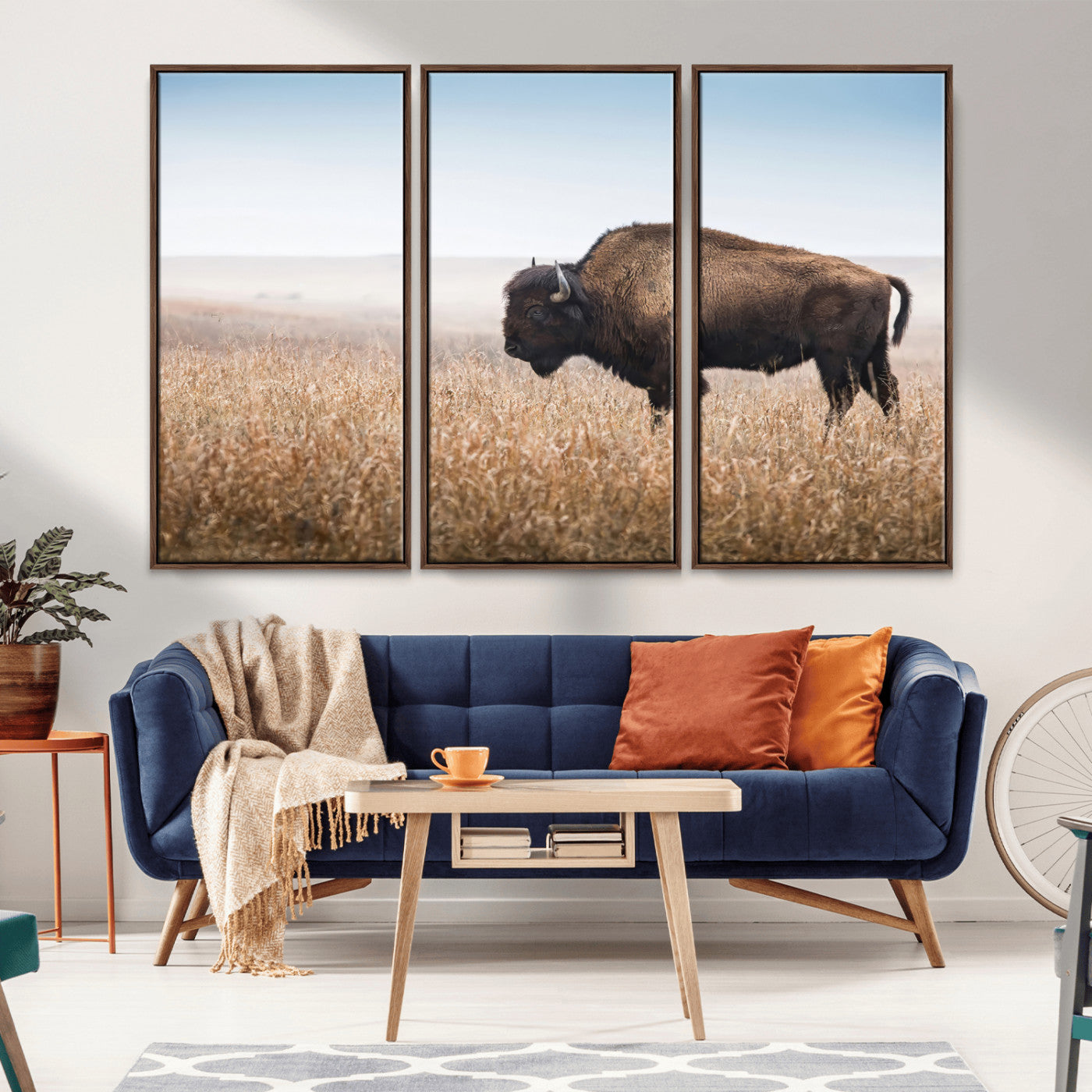A majestic bison standing in an open prairie field, its strong form blending into the golden grass under a vast blue sky, evoking the wild spirit of the American plains.