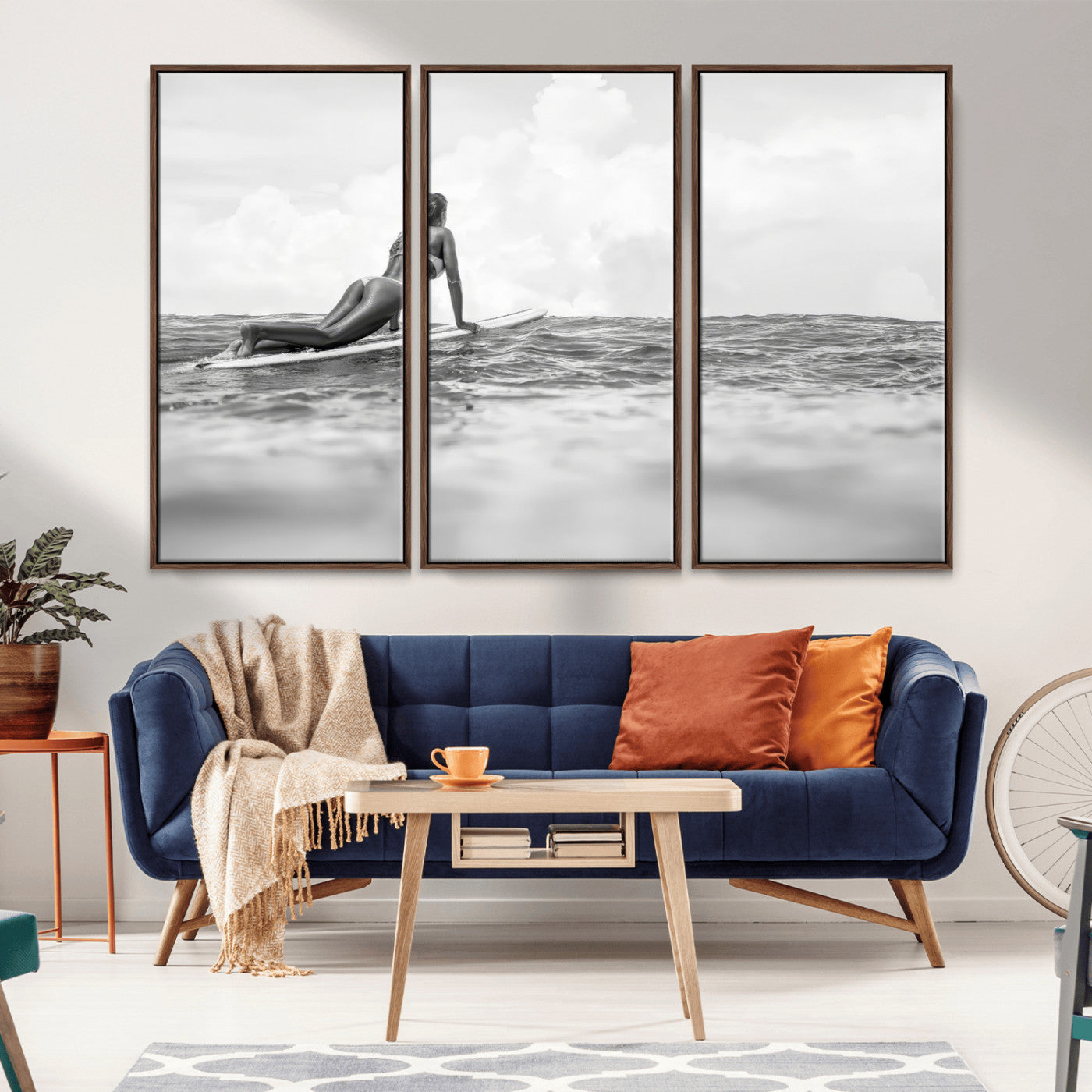 A black and white ocean scene featuring a surfer girl waiting on her board, gazing at the horizon, capturing a tranquil and adventurous coastal moment.