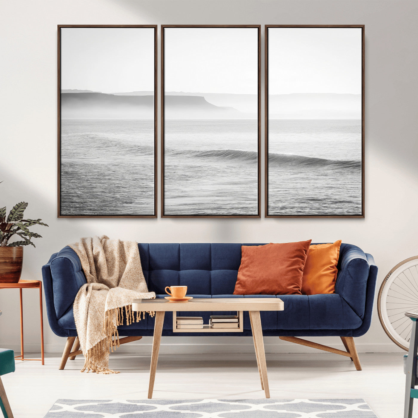 A black and white minimalist seascape featuring soft rolling waves and misty distant cliffs, creating a serene and timeless coastal atmosphere.