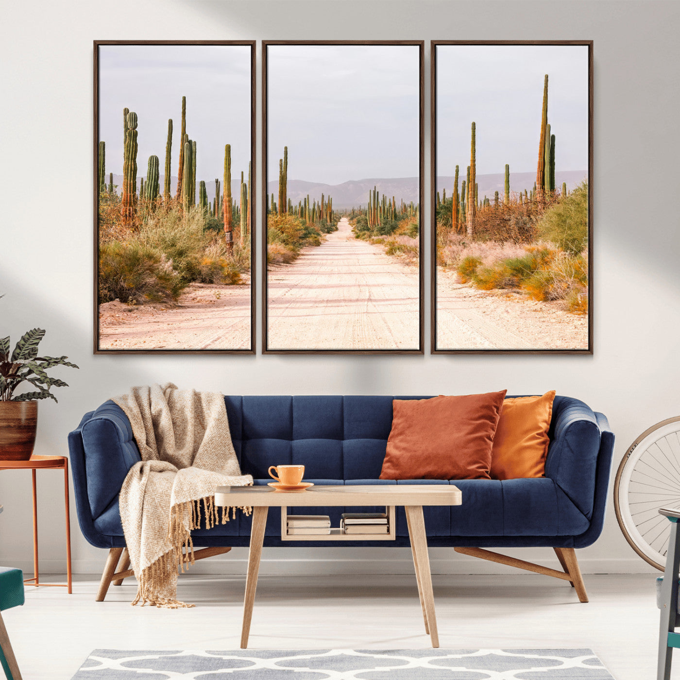 A desert road lined with saguaro cacti under a golden sky, creating a warm southwestern feel, perfect for boho or rustic decor.