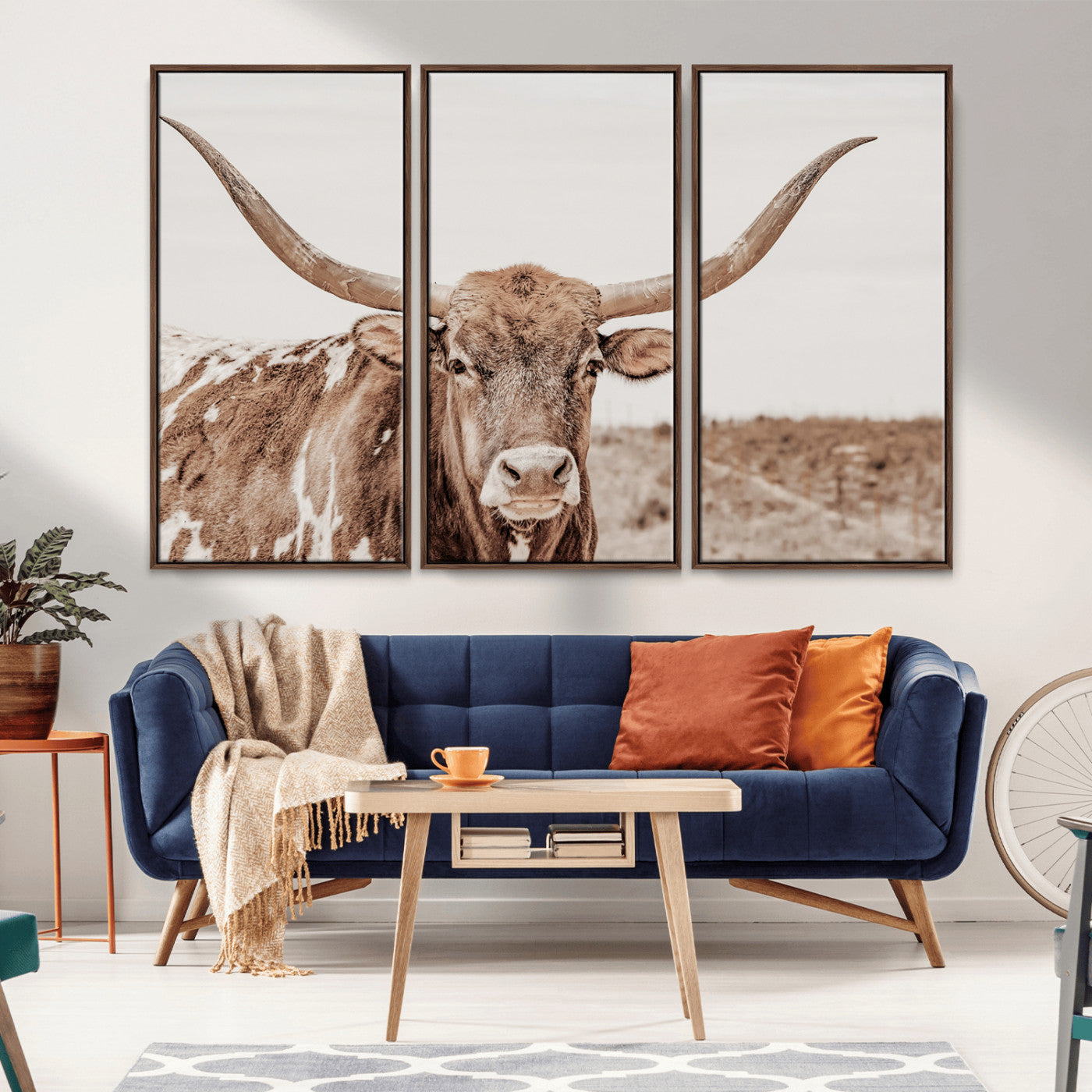 A longhorn cow in soft beige desert tones, standing calmly in open land, perfect for neutral western or rustic farmhouse interiors.