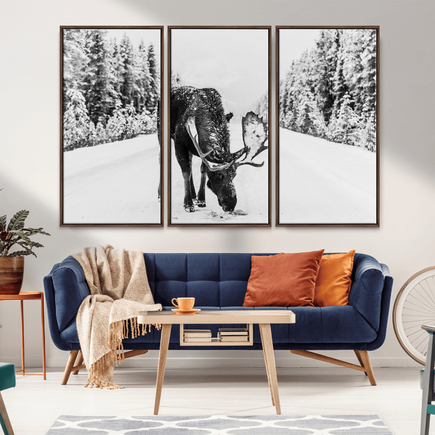 A majestic moose grazing in the snow-covered wilderness, surrounded by snow-covered trees, creating a peaceful winter scene.