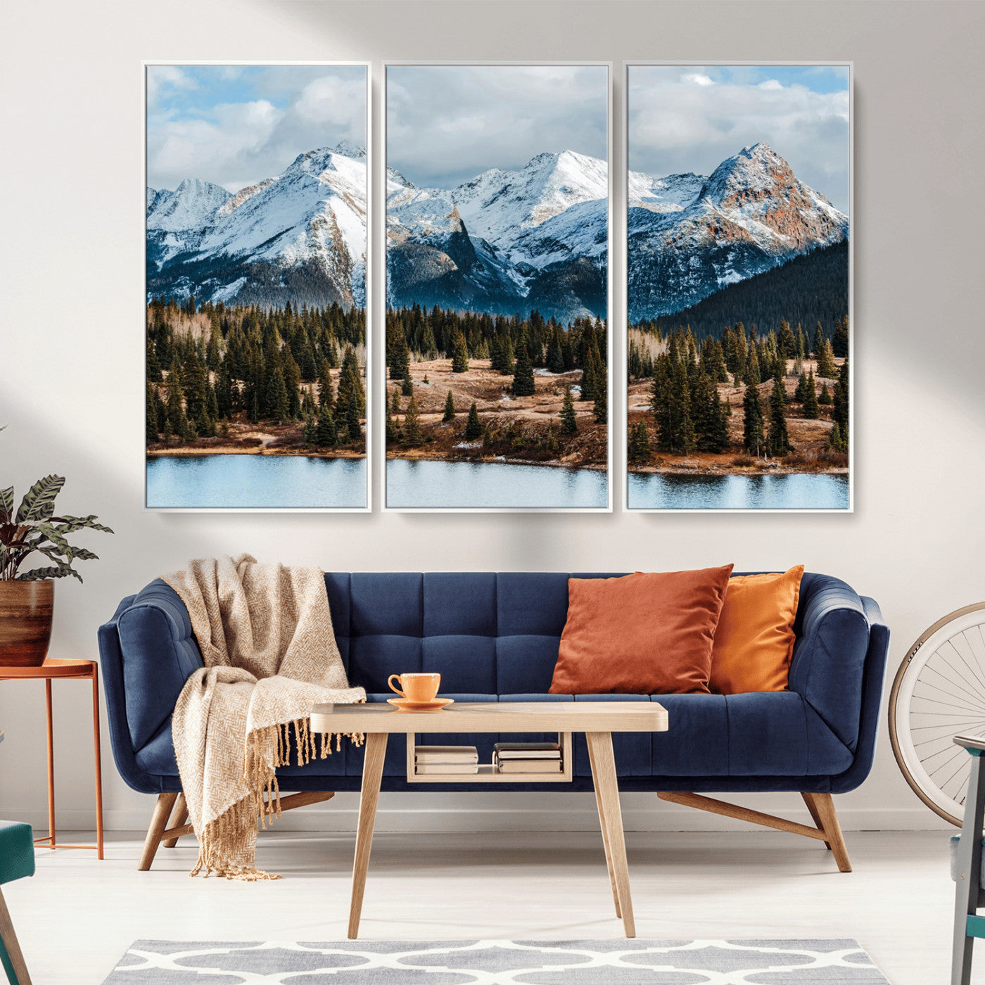 Framed canvas of snowy mountain peaks with pine forest and alpine lake, perfect for winter cabin or wilderness-inspired home decor.