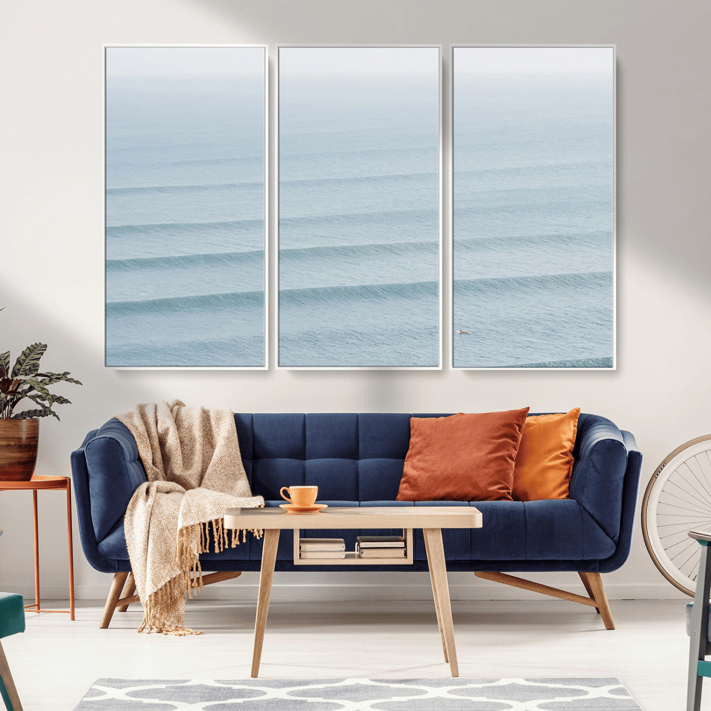 Framed canvas of repeating ocean waves with a distant solo surfer, ideal for minimalist ocean or calm coastal wall decor.