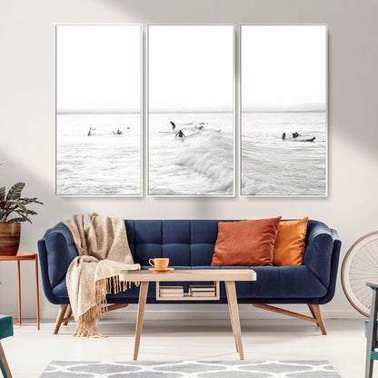 Monochrome photo of surfers riding and waiting on ocean waves, ideal for surf-themed or coastal energy wall decor.