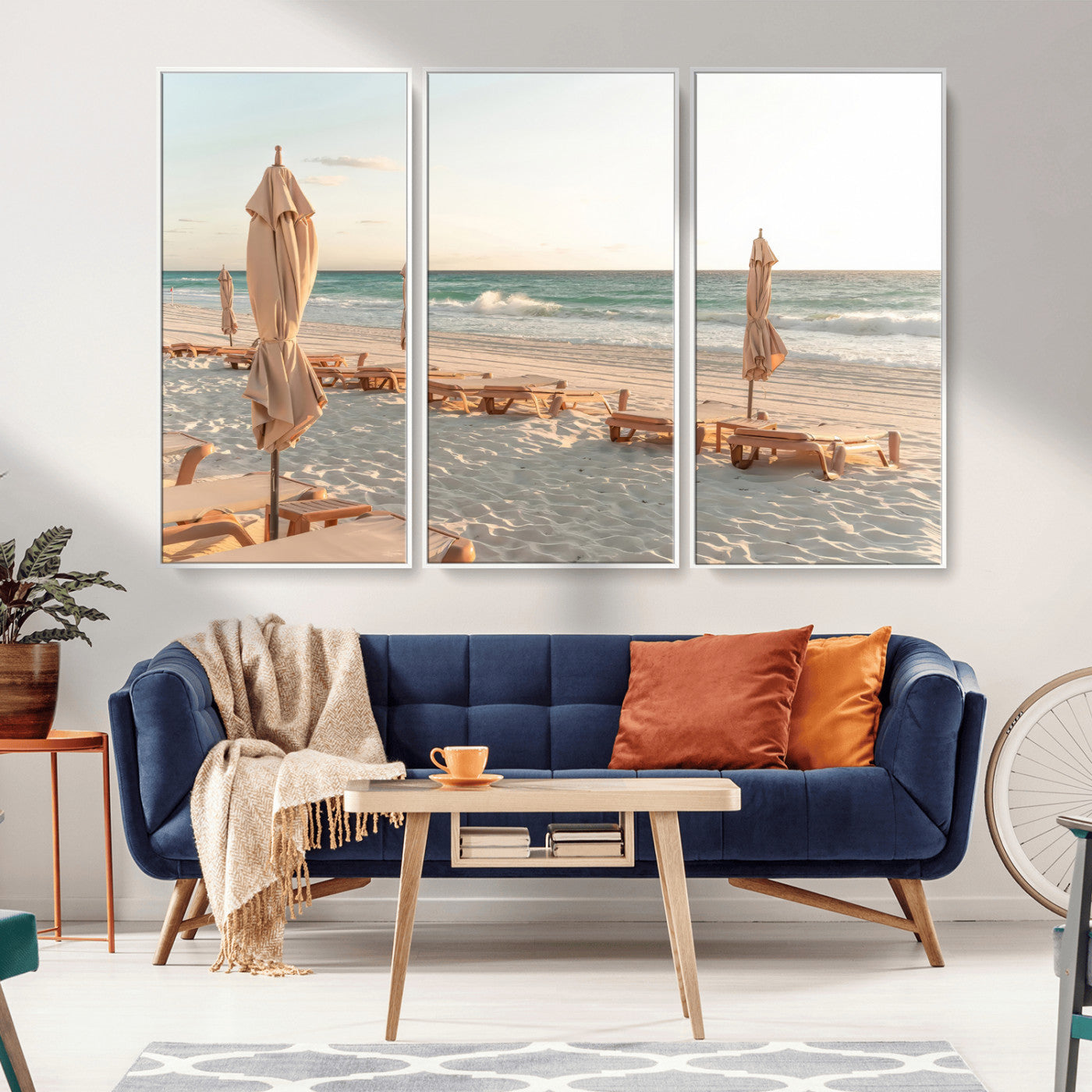 Minimalist photo of empty beach loungers and umbrellas on soft sand, ideal for calm seaside or pastel coastal-style home decor.
