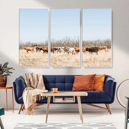 Framed wall art of Texas longhorn cattle walking through a dry, neutral-toned prairie, perfect for rustic farmhouse or western-themed home decor.