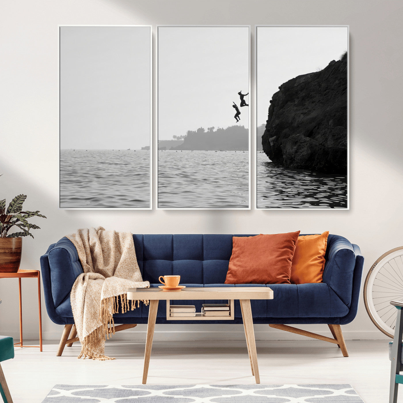 Black and white canvas of two figures cliff jumping into the sea, captured with moody tones, ideal for modern coastal or adventure-themed home decor.   2/2